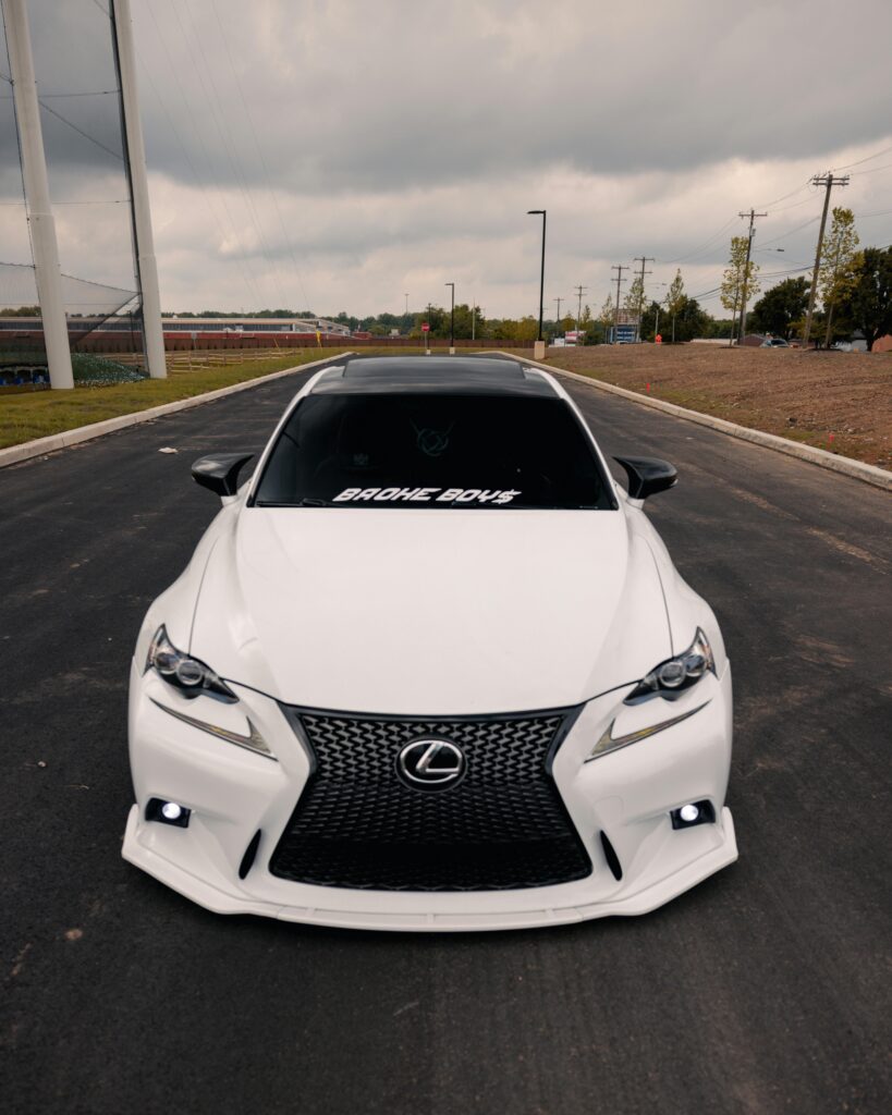 Sleek white Lexus sedan parked outdoors on a Philadelphia street, showcasing luxury and style.